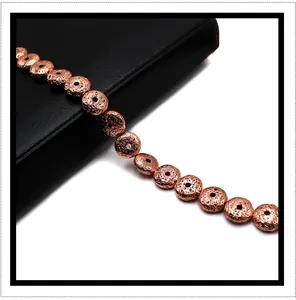 Macro shot of rose gold plated porous volcanic stone beads on black leather for DIY bracelets