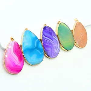 Five colorful teardrop agate pendants with gold plated edges on a white background