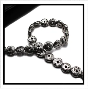 Macro view of silver volcanic lava beads with porous texture for jewelry making