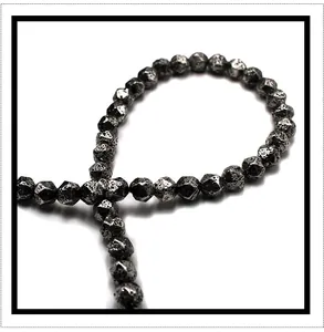 Close-up of faceted electroplated volcanic stone beads with metallic finish for jewelry