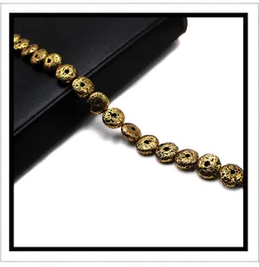 Detailed view of golden electroplated lava rock beads with porous texture for DIY jewelry