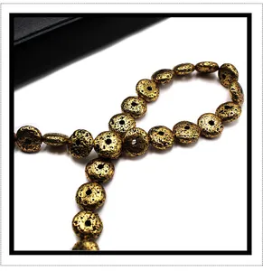 Macro shot of metallic golden lava stone flat round beads with porous texture for DIY jewelry