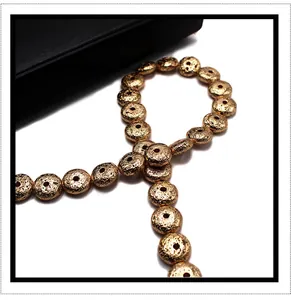 Macro view of gold plated flat round lava stone loose beads for DIY jewelry making