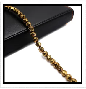 Macro shot of faceted metallic volcanic lava stones in antique gold for DIY jewelry