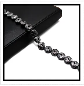 Macro shot of flat round black lava stone beads with porous texture for DIY jewelry