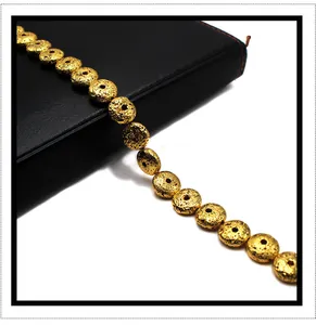 Macro detail of golden electroplated volcanic lava stone beads with porous texture