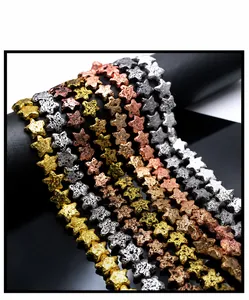 Macro shot of star-shaped volcanic lava beads in gold, silver, and metallic finishes
