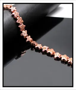 Macro detail of rose gold star-shaped lava stone beads with textured volcanic surface