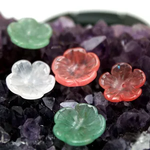 Macro detail of hand-carved natural jade flower petals with central drill holes for DIY jewelry