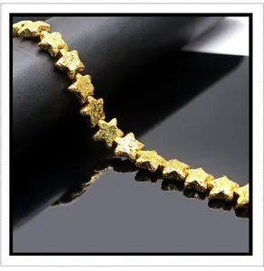 Macro di perline a stella in pietra vulcanica dorata con trama opaca per gioielli fai da te