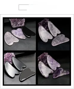 Makroansicht polierter herzförmiger Gua Sha Massage-Tools aus Rosenquarz und Obsidian
