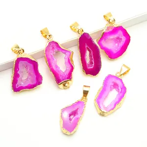 Natural agate geode slice pendants with gold plated edges on a clean white background