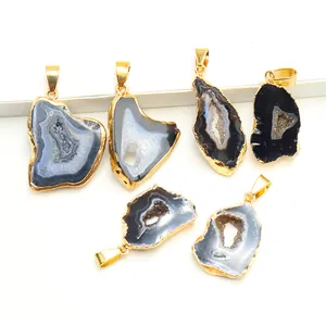 Macro view of natural geode pendants with irregular shapes and gold plated edges