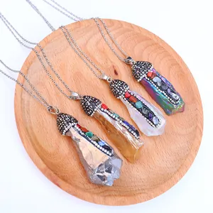 Natural crystal pendant necklaces with colorful rhinestones on a rustic wood tray