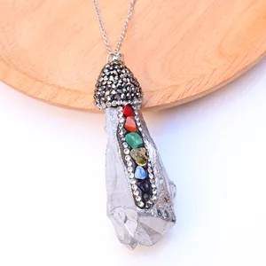 Macro shot of silver mushroom pendant with rainbow chakra stones and grey rhinestones