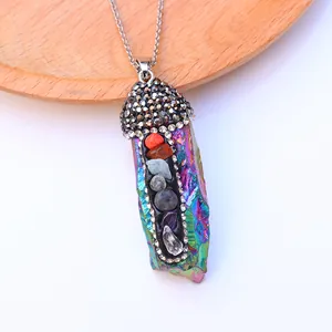 Macro detail of 7 chakra natural stones on iridescent crystal pendulum necklace pendant