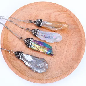Natural crystal pillar necklaces in four colors on a wooden tray for yoga jewelry style