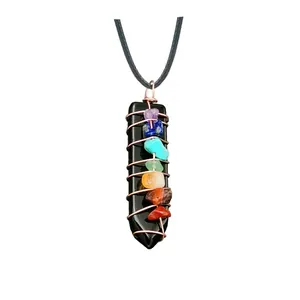 Detailed close-up of wire wrapped black obsidian arrow pendant with seven chakra stones