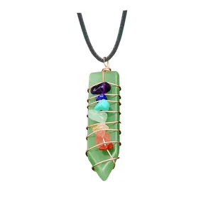 Detail of green aventurine chakra pendant with copper wire wrap and seven crystals