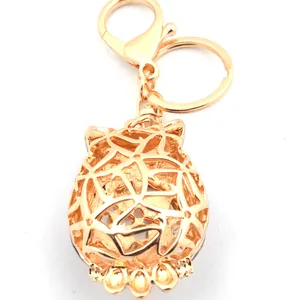 Golden hollow owl keychain with rhinestone cat eye stone and lobster clasp for women