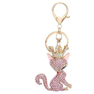 Cute pink fox keychain with rhinestones and crown detail on a gold metal clasp