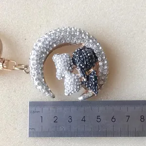 Detail of moon and bear keychain with rhinestones and ruler showing 4cm width