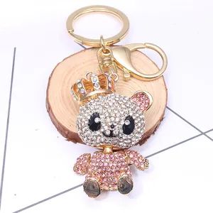 Macro detail of luxury bear keychain featuring pink rhinestones and a gold crown