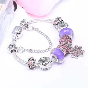 Silver snake chain bracelet with purple glass beads and lucky clover charms