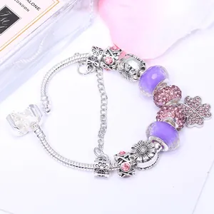 Fashionable purple beaded bracelet with clover pendant and faceted glass beads on snake chain