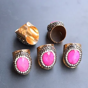 Adjustable gold hammered ring with oval rose red agate and double row crystal border