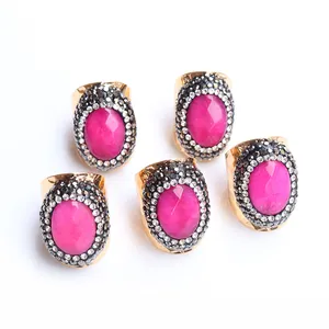 Five-piece set of adjustable gold rings with oval rose red agate and pavé crystals