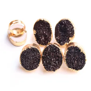 Macro detail of natural druzy agate rings with gold-plated adjustable open bands