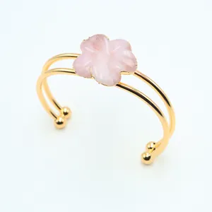 Detail of pink crystal flower petal double-ring gold-plated bracelet on white background