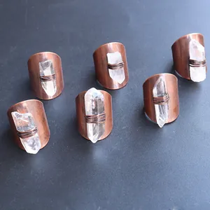 Detailed view of handcrafted copper rings with raw white crystal stones in vintage style
