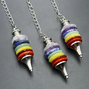 Close-up of stacked seven chakra natural stone pendulum with silver metal chain