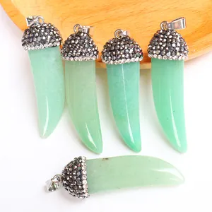 Macro detail of five horn-shaped light green natural stone pendants with pavé crystal accents