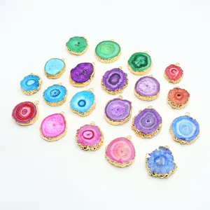 Handcrafted colorful agate crystal sunburst pendants with gold plated edges on white background