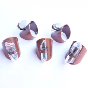 Detailed view of five raw clear quartz crystal rings with vintage copper wire wrap