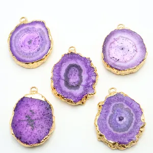 Detail of five purple agate slices with natural crystal textures and gold-plated edges