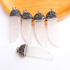 Detail of horn shaped natural crystal pendants with pave rhinestone caps and silver rings