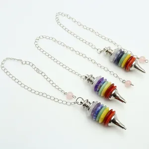 Macro view of seven chakra natural crystal stone pendulum with silver chain and rose quartz bead