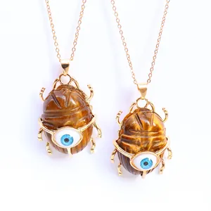 Natural tiger eye stone scarab beetle pendant necklace with blue evil eye detail