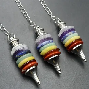 Detail of seven chakra crystal stones in a silver cone pendant with long bead chain