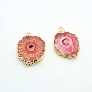 Macro detail of natural geode agate pendants with elegant gold plated metal edges