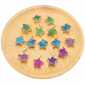 Star-shaped natural agate druzy pendants with gold edges on a wooden tray