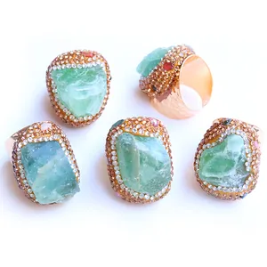 Detailed macro view of 5 bohemian open rings featuring raw green fluorite and rhinestones
