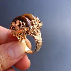 Vintage gold open ring with tiger eye stones and intricate filigree flower patterns