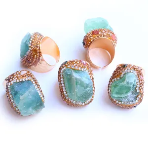 Five-piece set of gold adjustable rings with raw green fluorite and crystal accents