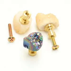 Detail of natural crystal cluster and raw stone furniture drawer pull with brass base