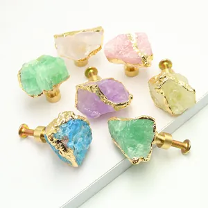 Detailed macro view of assorted natural crystal stone cabinet knobs with gold brass bases